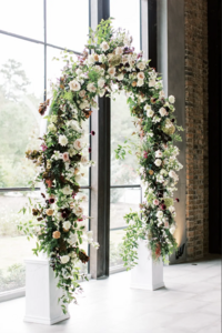 Wedding Photography, large floral archway setup by window