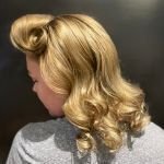 Side view of Allison’s glamorous vintage-inspired curls and victory roll hairstyle by Your Girl Friday LV.