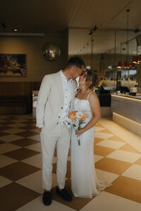 couple sharing a kiss at their st kilda wedding