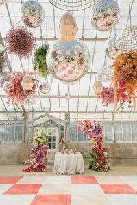 destination wedding planner decorates with bright florals and disco balls