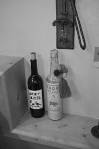 Two bottle sitting on a shelf