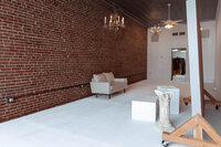 Natural-light photography studio with white walls, modern furniture, and white couch in Troy, MO