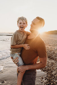 family fun relaxed photoshoot on the beach at sunset in Hampshire and Dorset