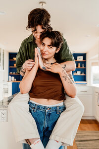 an LGBTQ+ couple embracing in their kitchen