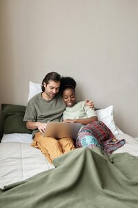 man and woman sitting together on computer