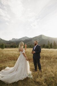Film photo of bride and groom walking hand in hand at outdoor wedding venue in California by idaho wedding photographer