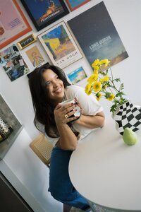 woman sitting at table with coffee cup