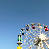 Colorful ferris wheel against clear blue sky