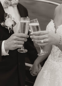 bride and groom clinking their glasses after just becoming husband and wife