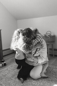Documentary-style family session at home, with playful and real-life moments captured by Maine photographers.