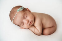 Infant posed for Newborn Photoshoot in Charleston, SC.