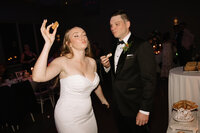 Couples candid photo after cutting the cake at their reception . Ottawa wedding, captured by editorial wedding photographer Stacy Kenopic