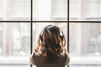 Canva - Woman Listening on Headphones