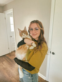 Cozy indoor portrait of woman with Maine Coon cat in pennsylvania