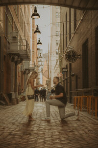 A man and woman spin around romantically spin around in the snowy forest