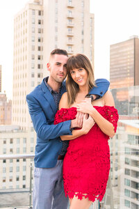 Couple hugging on rooftop in Dallas,