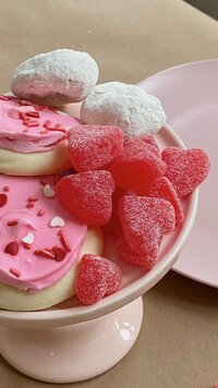 Bowl of pink candies and confectionary goodies that match this website design aesthetic of fun and bold color pops.