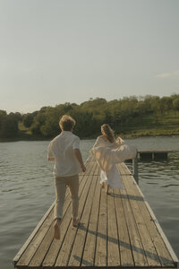 Couple running by the lake