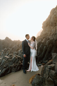 A bride and groom at Laguna Beach near the rocks. 