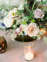 Fresh flower reception centerpiece with votive candle