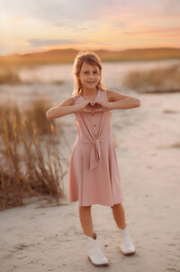 Little boy smiles into the camera during Family Portraits on Folly Beach.