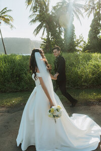 bride and groom walking on beach