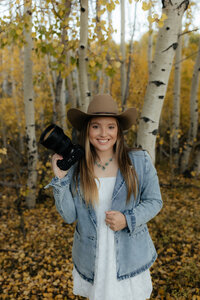 Self-portrait of a Wyoming-based wedding and lifestyle photographer, capturing a professional and artistic shot