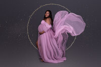 lady dressed in pink in the maternity photostudio