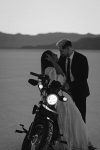 Couple elopes on the Bonnevillle Salt flats with their motorcycle.