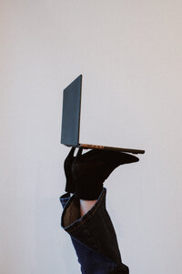 A women working on laptop in professional clothing. 