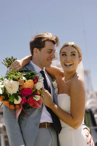 Wedding portraits of the bride and groom with her veil and florals