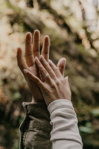 couples hands with engagement ring