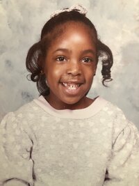 little girl in grey sweater smiling