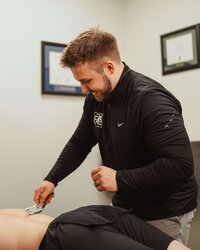 Therapist providing manual therapy to relieve patient’s back pain