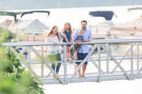 Family gathers for portrait on a dock