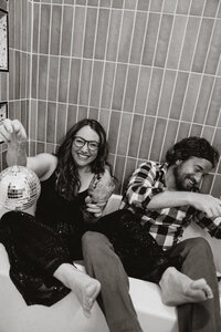 Couple partying in a bathtub with champagne and a disco ball in Breckenridge, Colorado.
