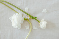 Close up of wedding bands and florals