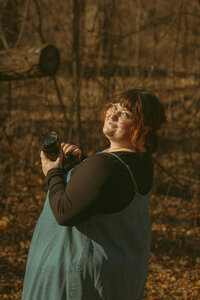 Photographer carefully arranging a flat-lay photo with wedding details