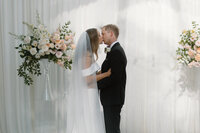 Bride and groom kissing in the wedding ceremony