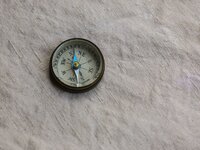 woman holding compass on a mountain