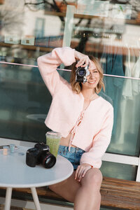Photographer, Katie Elizabeth, poses on beach
