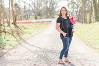 A mother holds her baby on a gravel path in Tennessee by Laramee Love Photography