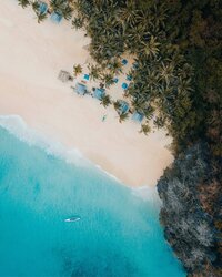 Untouched island beach destination available via personalized itinerary consultation. Tailored Oasis Travel Co.