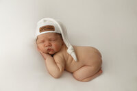 chunky baby boy sleeping with hat on