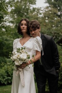 bride and groom outside by barn