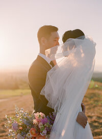 a romantic view of a couple at sunset on their wedding day at newcastle golf club