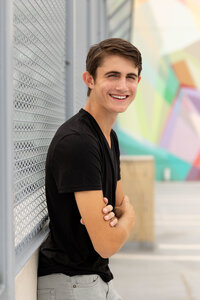 Senior guy senior portrait taken in Detroit at colorful rooftop.