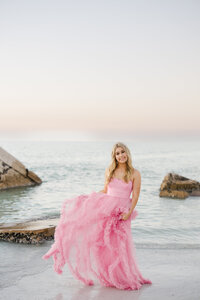 Senior girl on beach in pink long dress. Tampa florida senior photographer. 