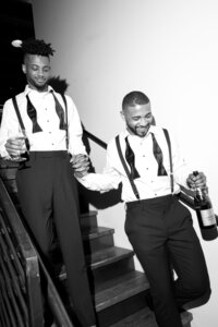 Two grooms walking down stairs at their LGBT wedding in Milwaukee Wisconsin