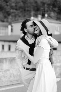 A candid black-and-white moment of a couple laughing